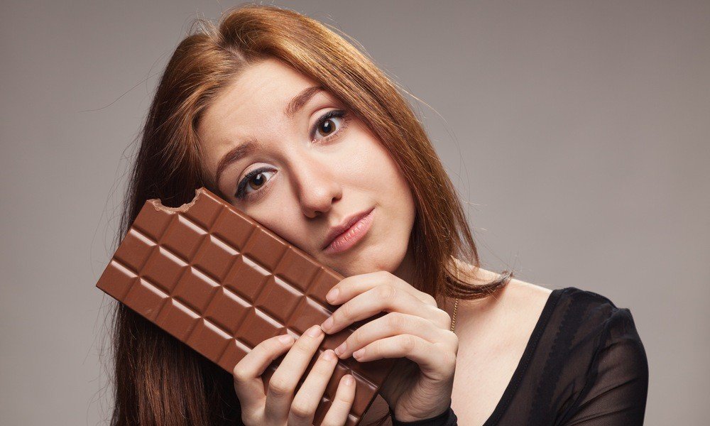 Sad young girl with the big chocolate