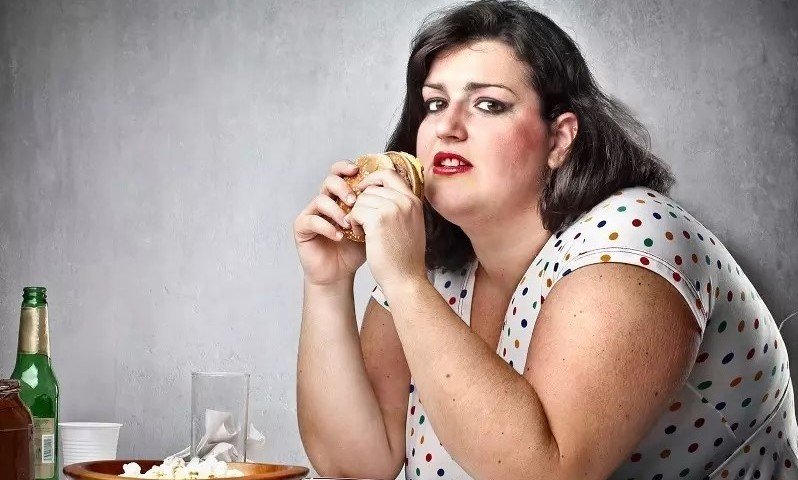 Overweight woman eating